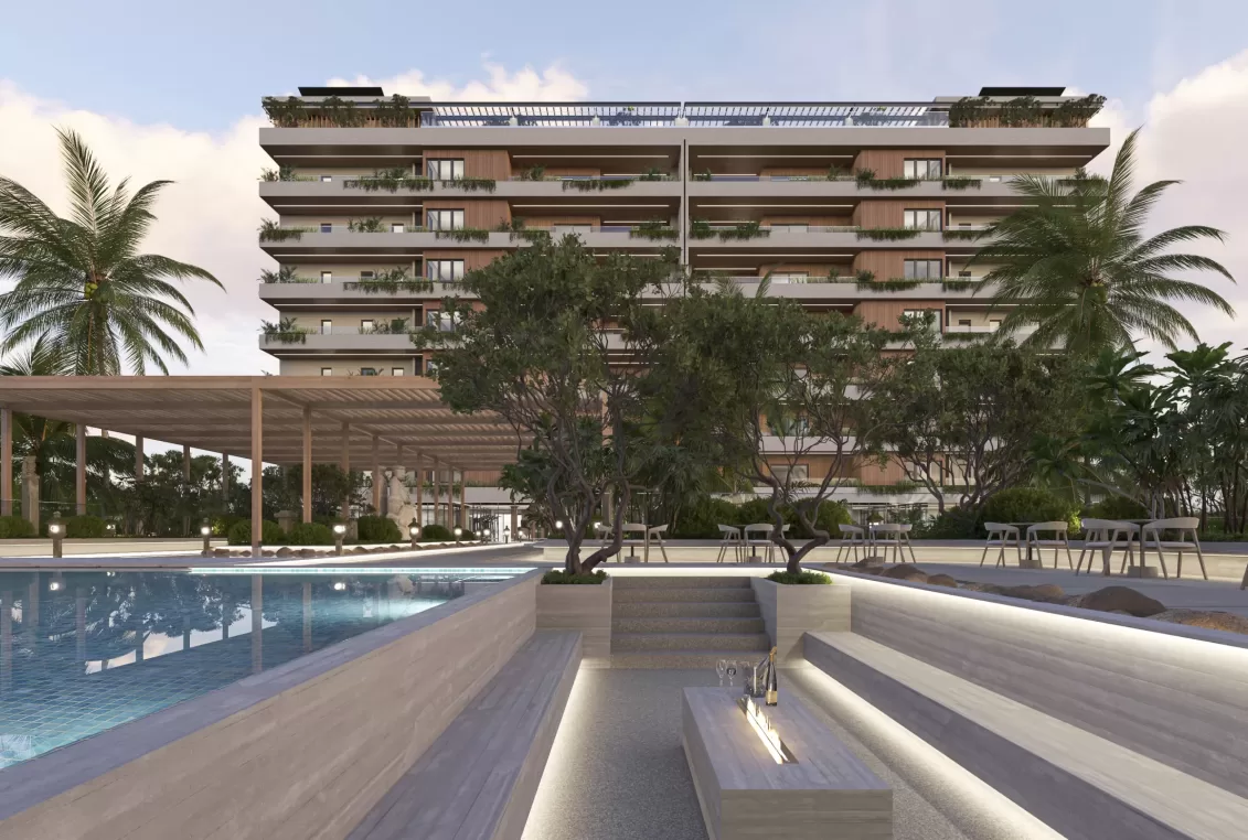 Área lounge con fogatero junto a la alberca principal en Zen Park Cancún, frente a la torre residencial.